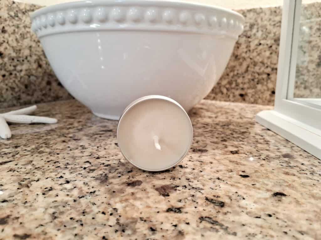 candle on the counter by  a bowl