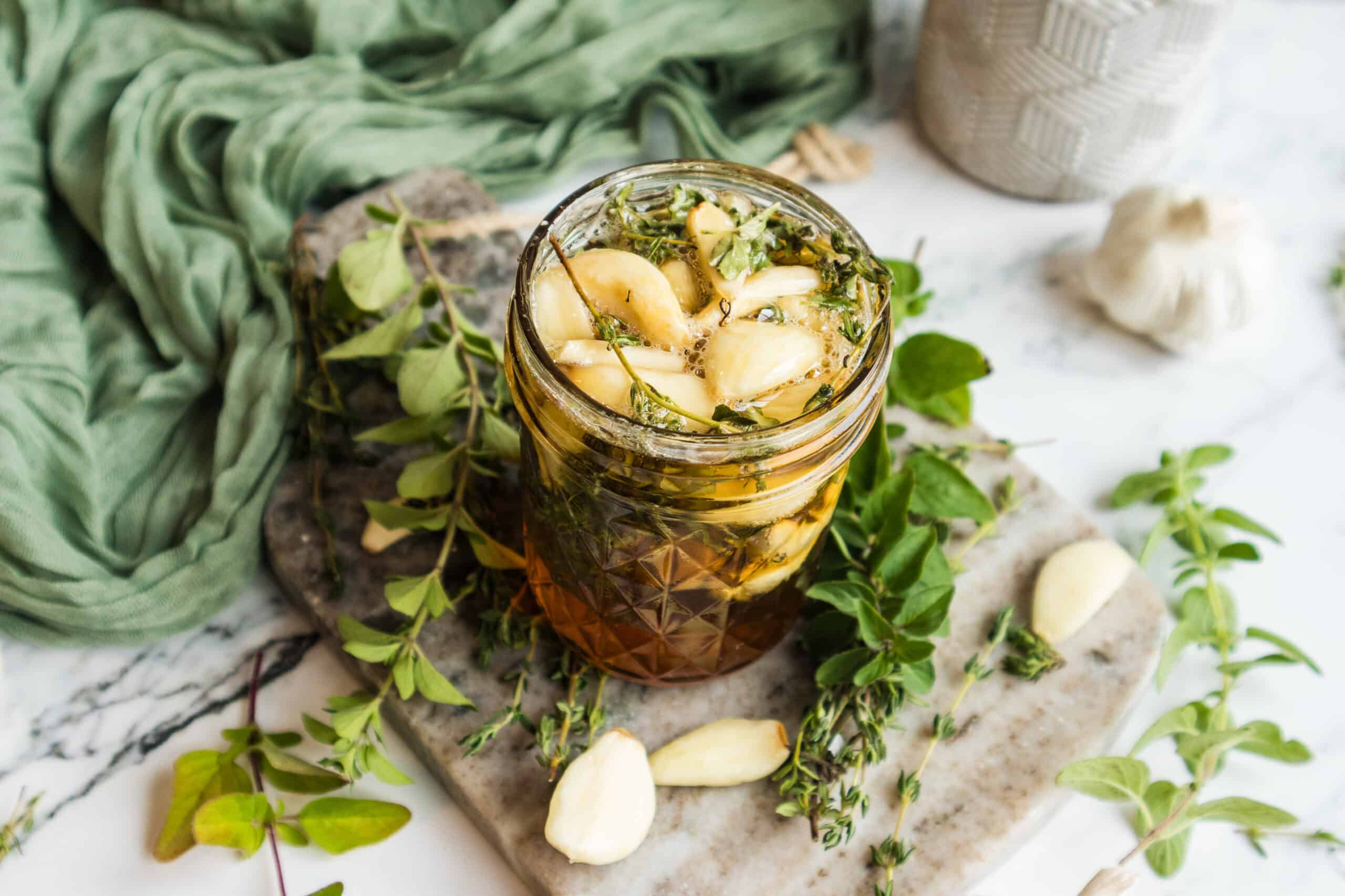 my homemade garlic infused honey recipe in a glass jar