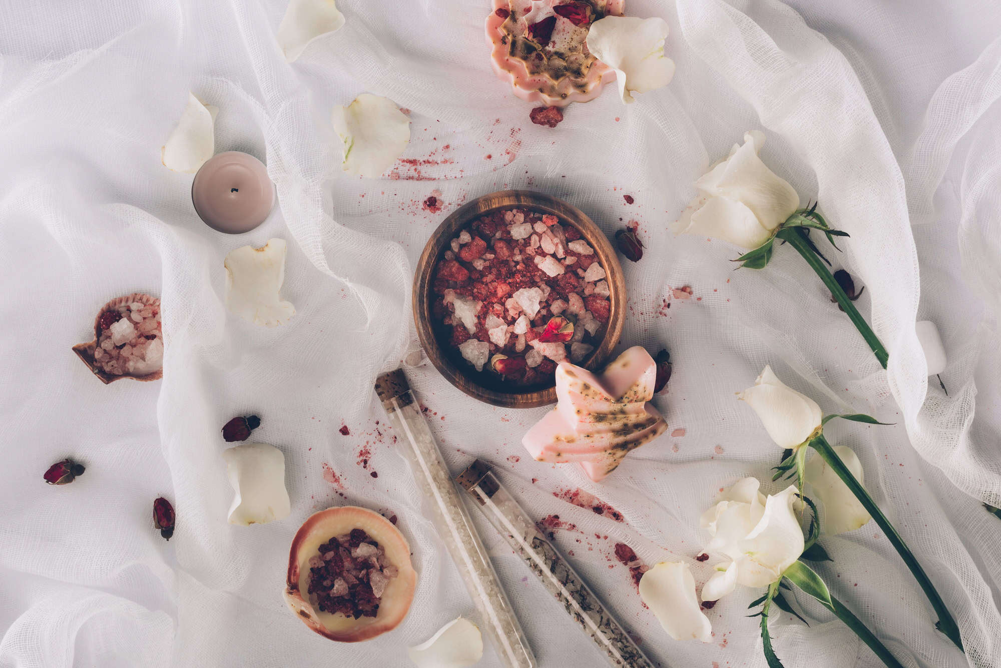 Handmade gifts made with rose petals, with roses next to them