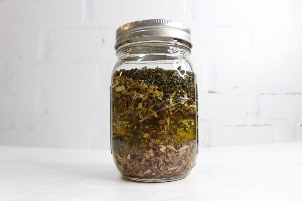 herbs in the jar full of oil for infusion