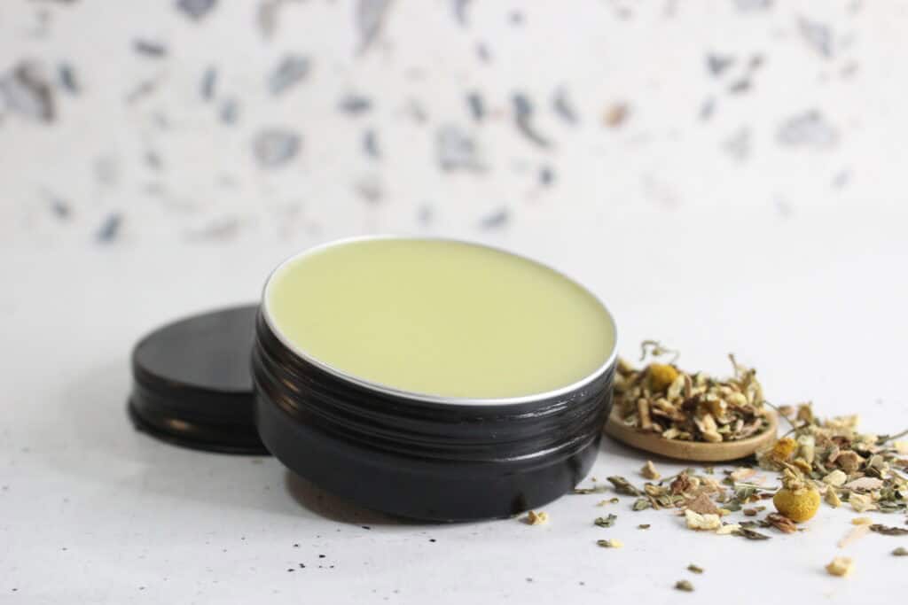 headache salve in black tin
