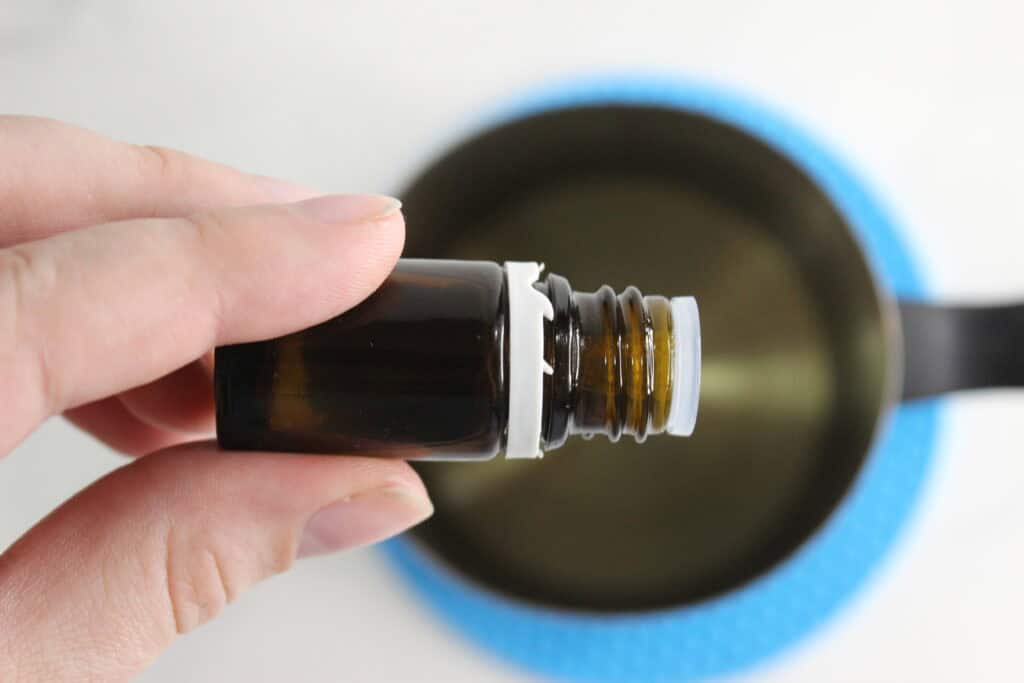adding essential oil to melted wax