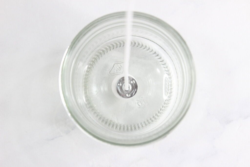 placing the wick in the jar