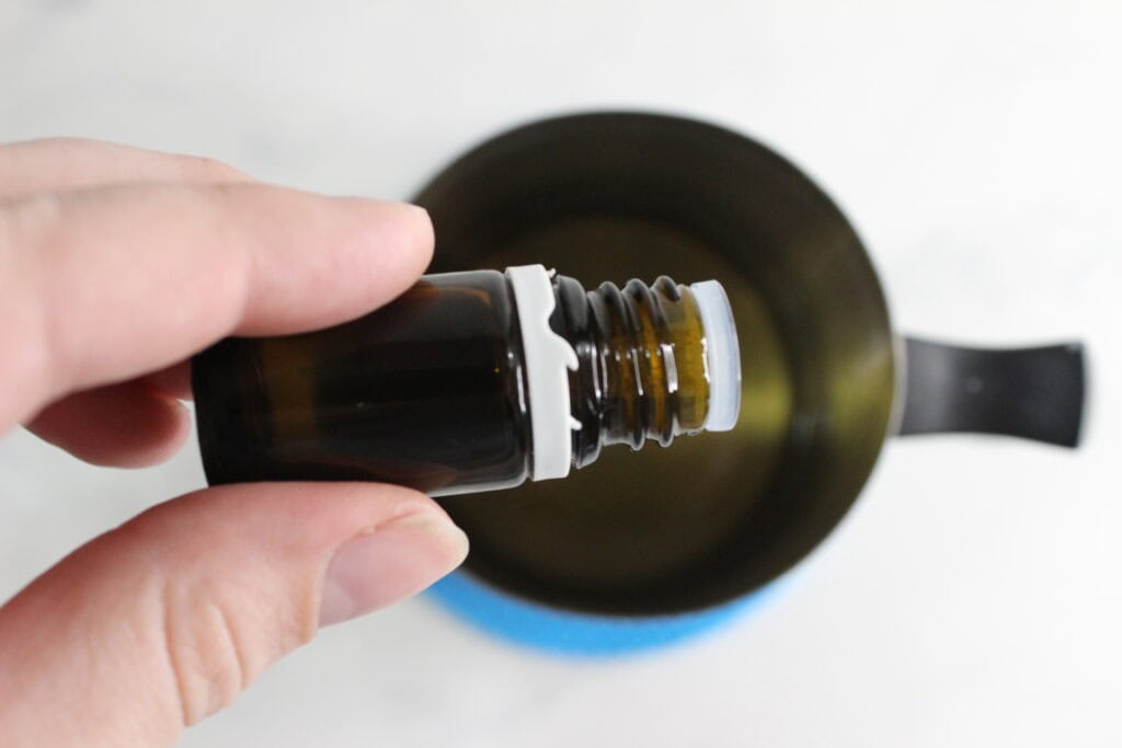 adding in essential oils to melted beeswax