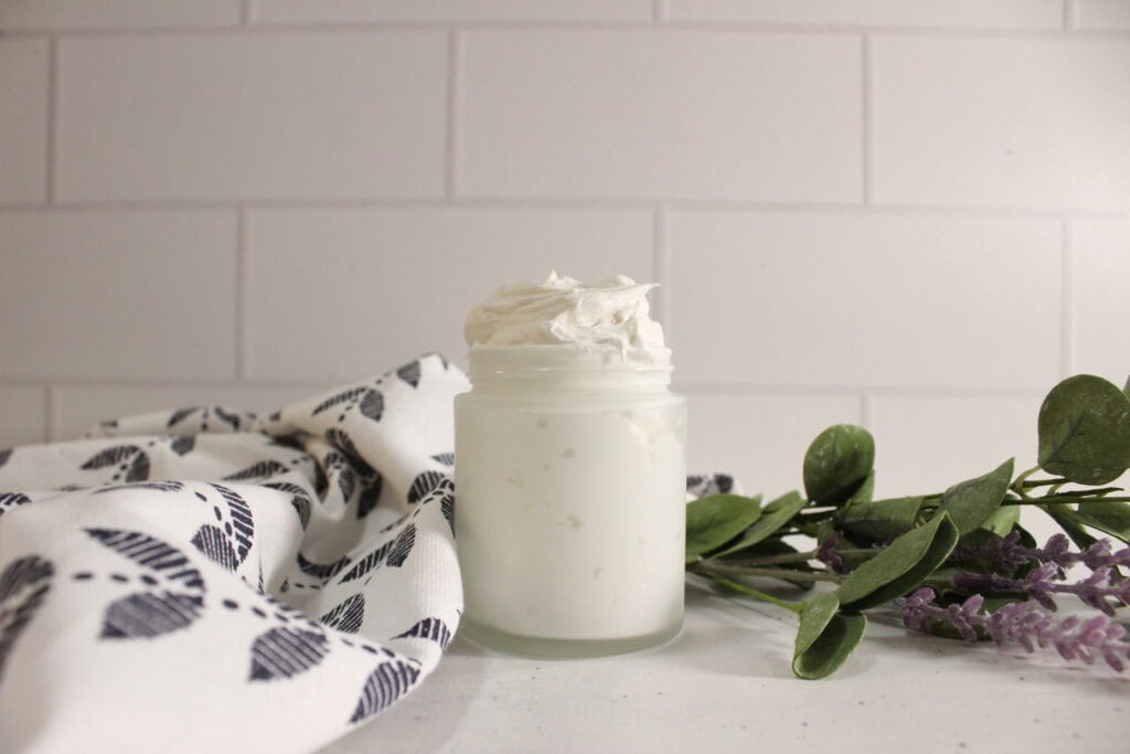 DIY CBD body butter in a jar on the counter