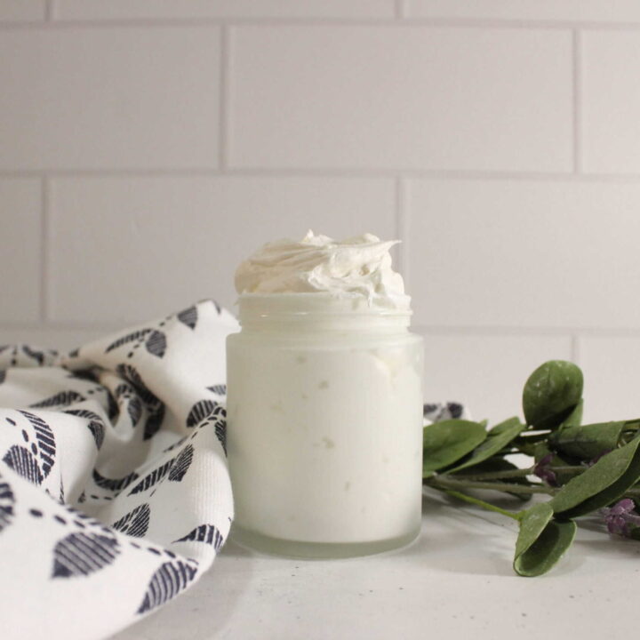 DIY CBD body butter in a jar on the counter