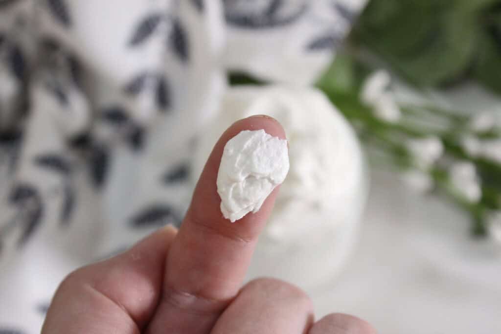 finger with some of the cbd body butter on it 