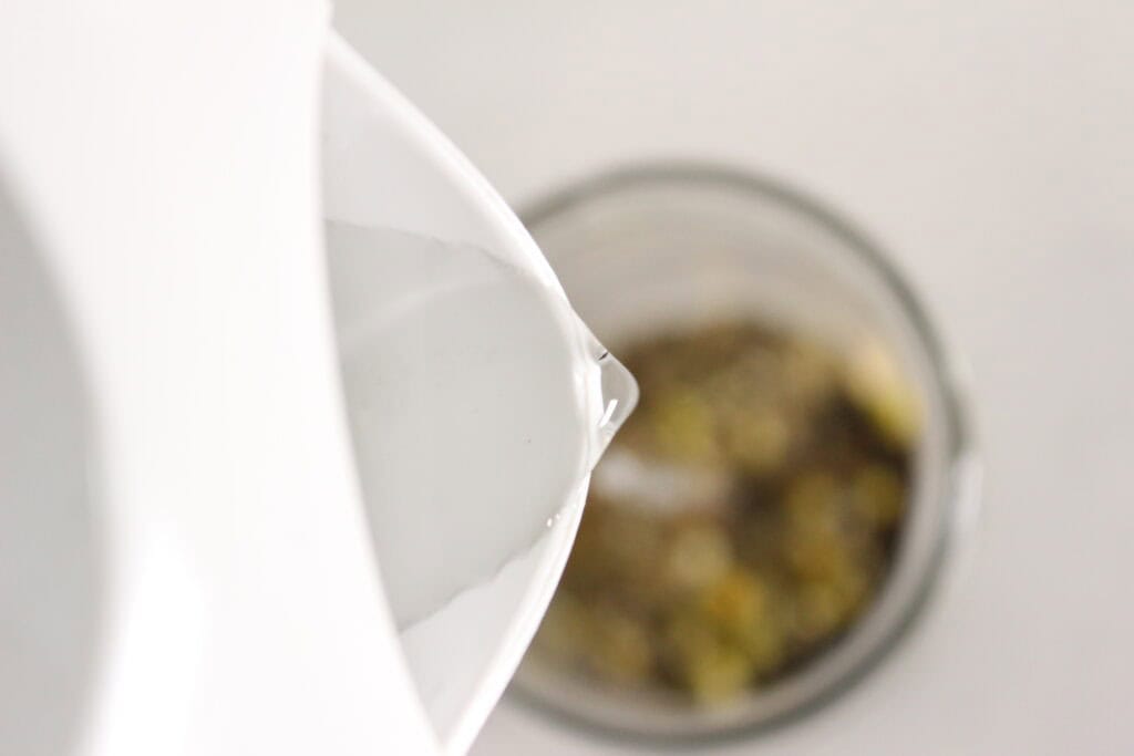 pouring water on herbs