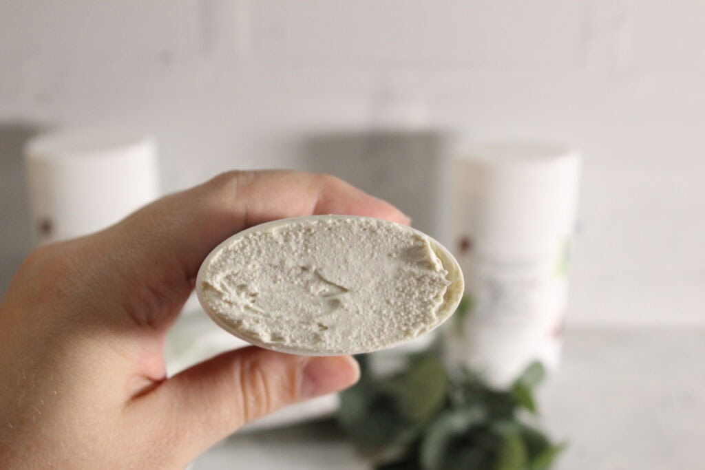 holding a tube of deodorant