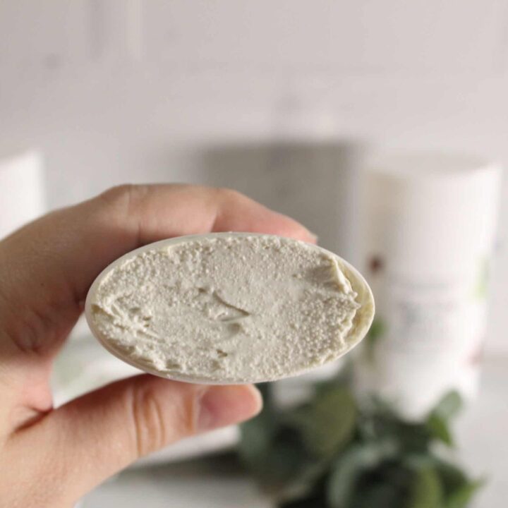 holding a tube of deodorant