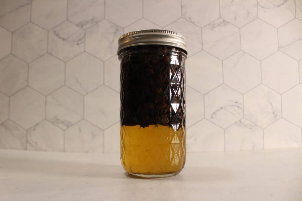 coffee-infused oil in a glass jar.