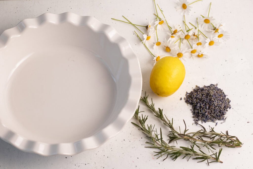 Lavender Simmer Pot ingredients bowl, lemon, lavender daisy, rosemary