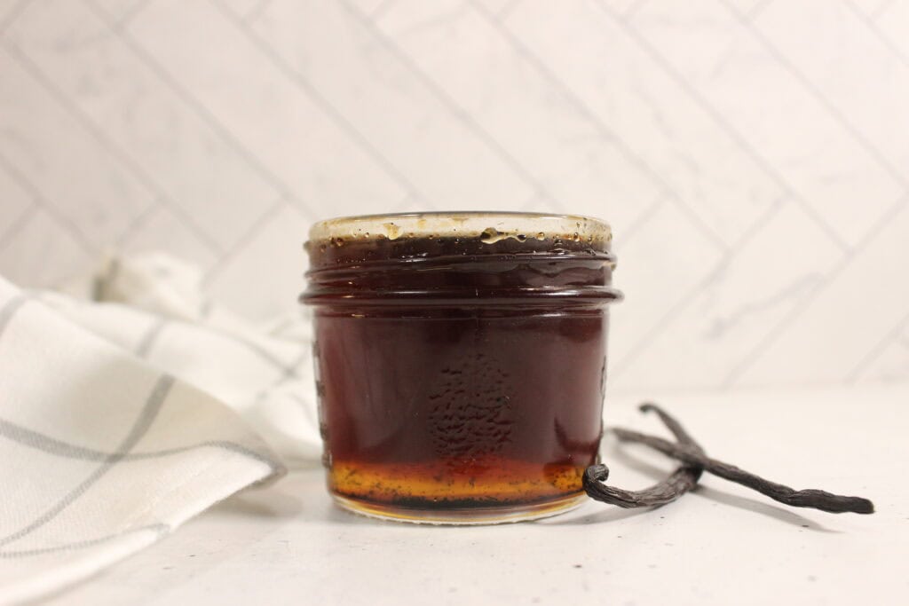 Homemade vanilla extract in a glass jar
