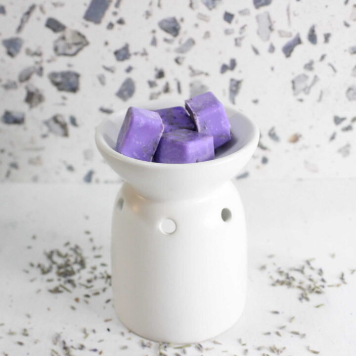 Lavender scented wax melts in a white dish for home fragrance.