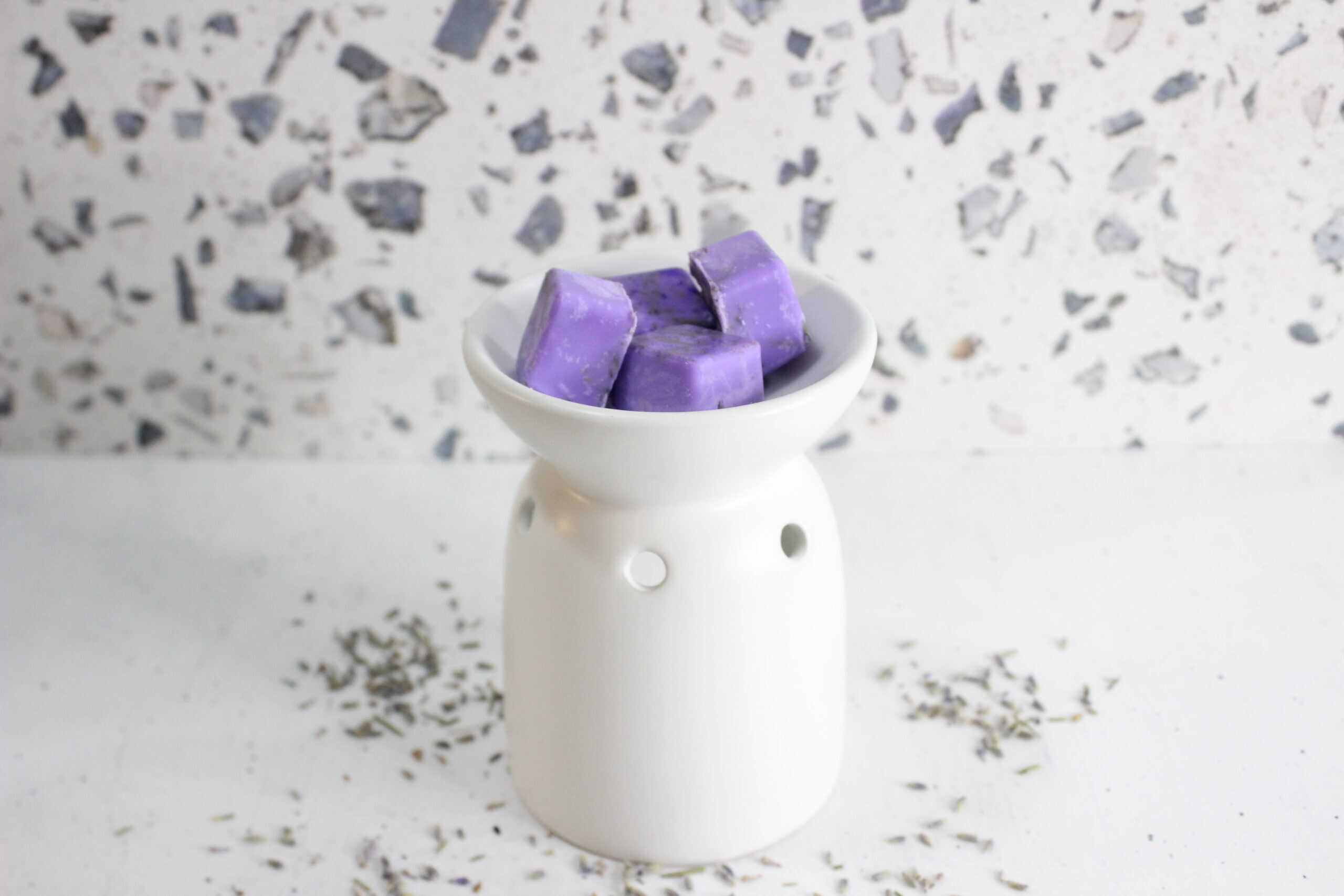 Lavender scented wax melts in a white dish for home fragrance.
