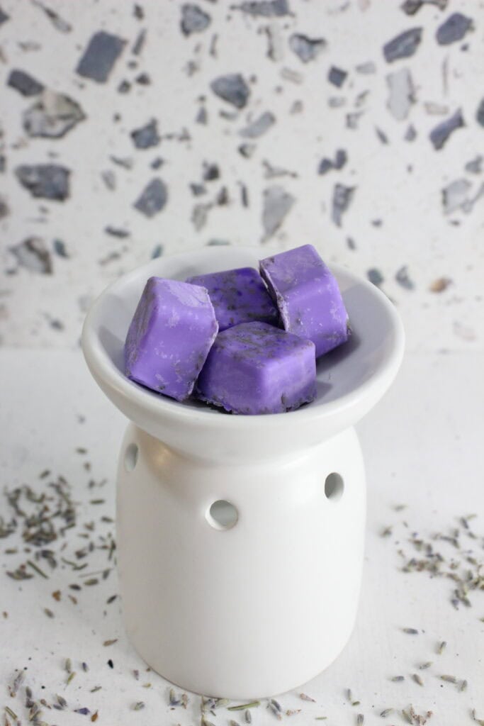 Lavender wax melts in a white dish, perfect for creating a calming aroma.