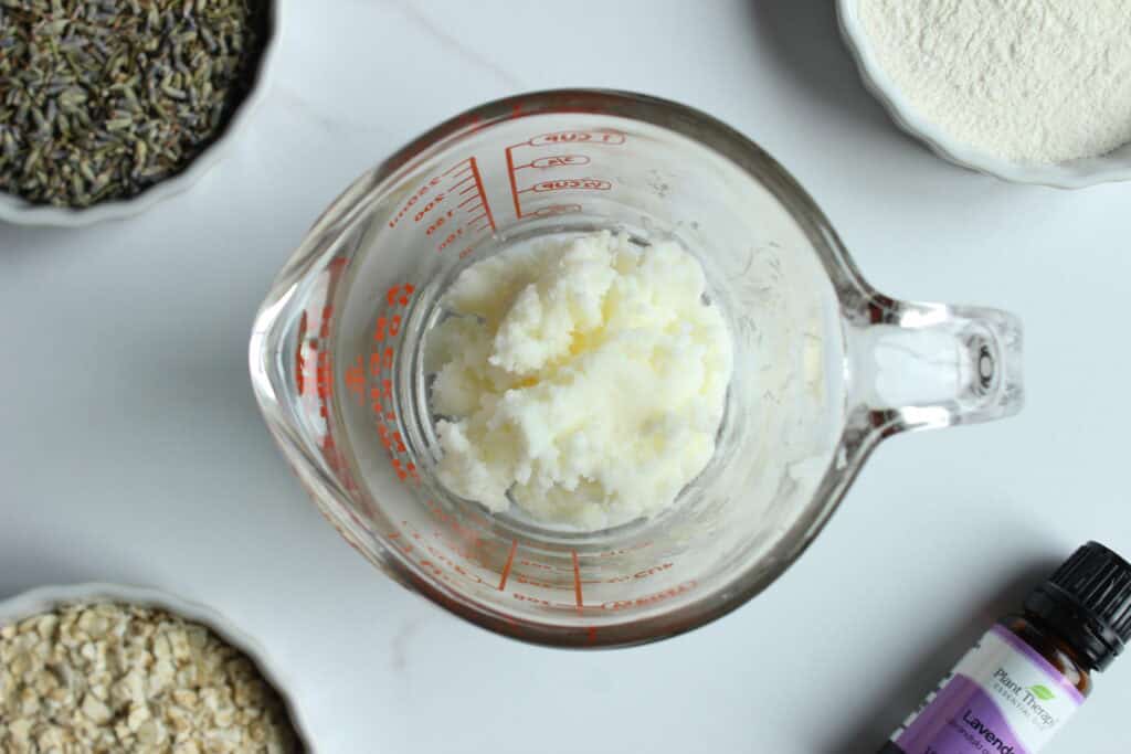 Melting tallow in a glass measuring cup.