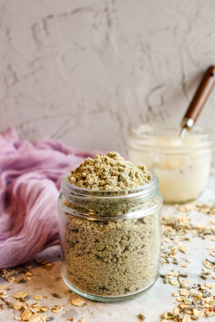 Lavender Tallow Oatmeal Face Scrub in a glass jar, perfect for gentle skincare.