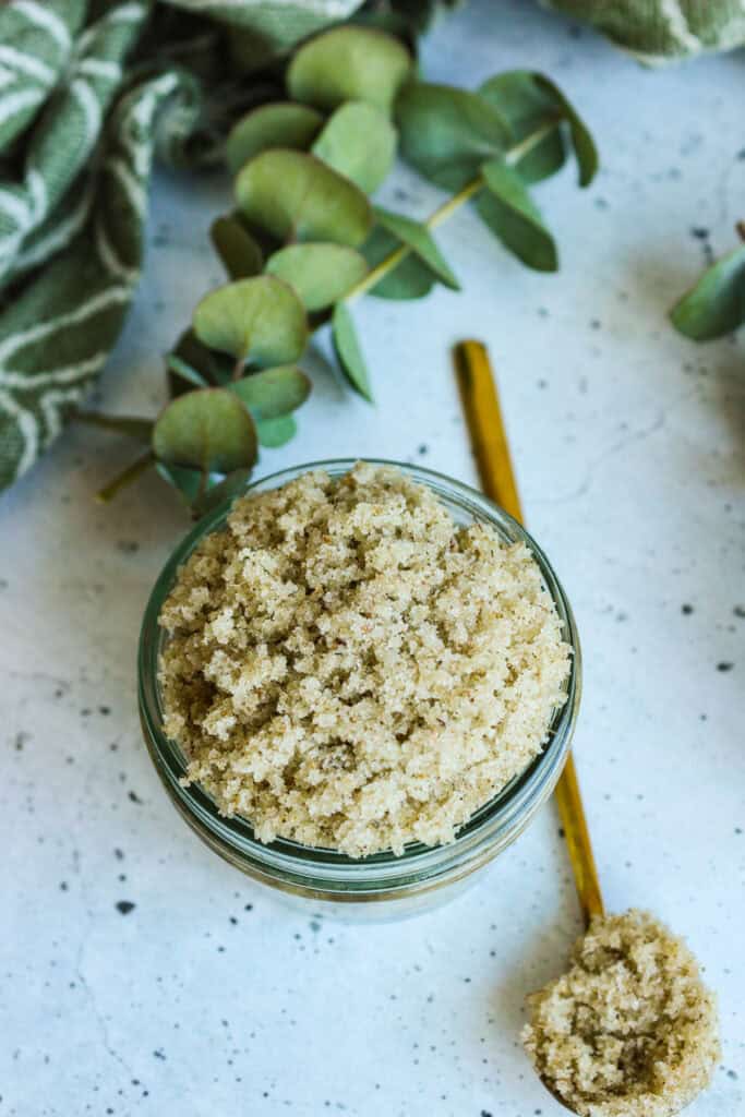 Eucalyptus sugar scrub in jar with spoon, natural skincare recipe.