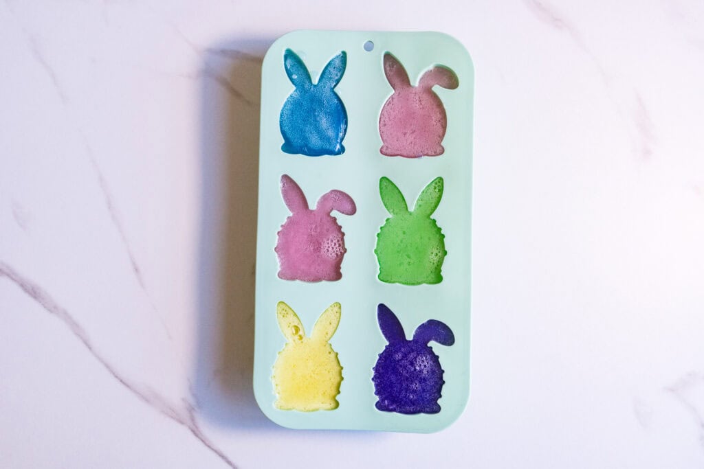 Easter Bunny soap mold with six colorful bunny-shaped soaps for DIY Easter crafts.