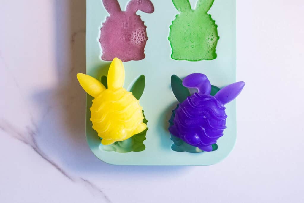 Easter Bunny soap mold with six colorful bunny-shaped soaps for DIY Easter crafts.