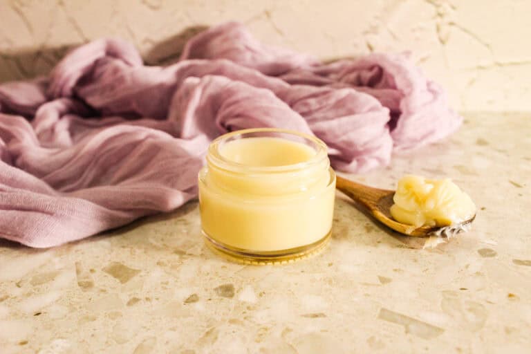 Close-up of a glass jar containing creamy heel balm.