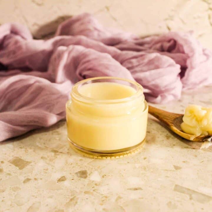 Close-up of a glass jar containing creamy heel balm.